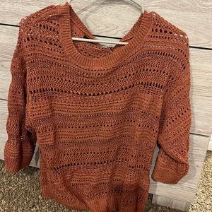 Burnt orange sweater.